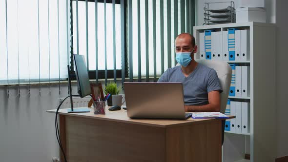 Man with Mask Having Online Meeting