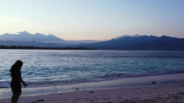 One girl happy and smiling on exotic island beach wildlife by blue lagoon with white sand background