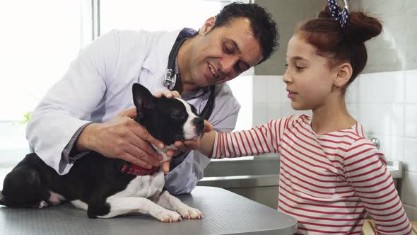 Little Girl and Her Cute Dog Visiting Professional Vet at the Clinic