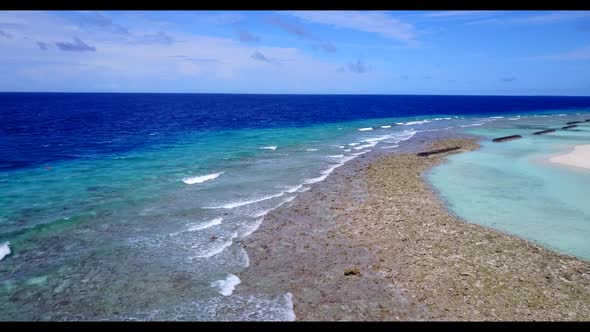 Aerial drone shot tourism of perfect coastline beach lifestyle by clear sea with clean sand backgrou