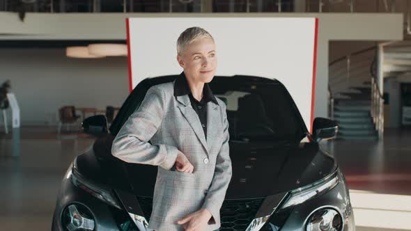 Positive Female in Smart Casual Clothes Smiling for Camera and Demonstrating