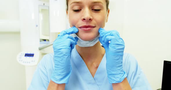 Dental assistant wearing surgical mask
