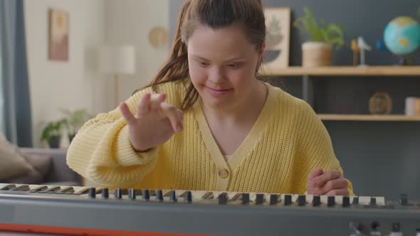 Girl with Down Syndrome Learning Synthesizer at Home