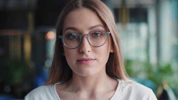 Portrait of smiling, young woman with glasses 