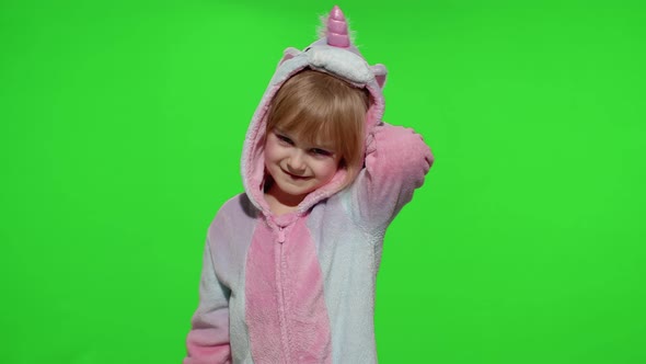 Little Blonde Child Girl Smiling Dancing Celebrating in Unicorn Pajamas Costume on Chroma Key