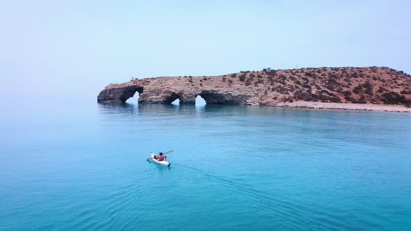 Kayaker rowning on tropical beach of Tripiti at the southern point of Gavdos island and Europe.