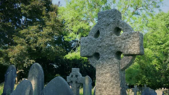 Passing Celtic Cross Gravestone In Churchyard