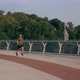 Young Man in Sports Uniform Runs on the Pedestrian Bridge at Dawn - VideoHive Item for Sale