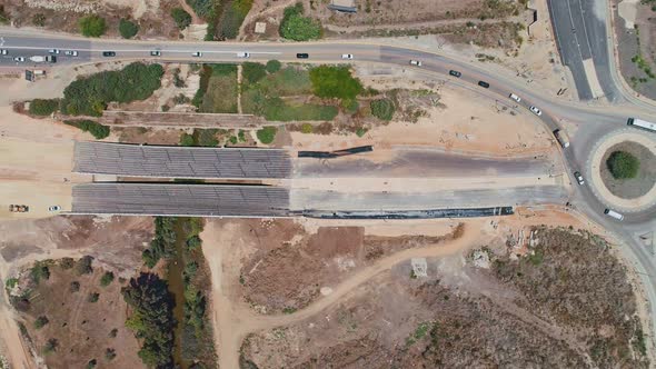 Aerial footage of large highway construction project with tunnels and bridges