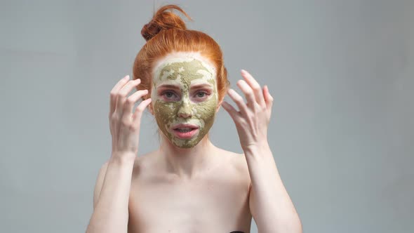 Beauty Portrait Face Mask. Anti-aging Facials. Young Woman Applies a Mask To the Face