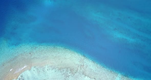 Natural aerial clean view of a white paradise beach and blue sea background in hi res 4K