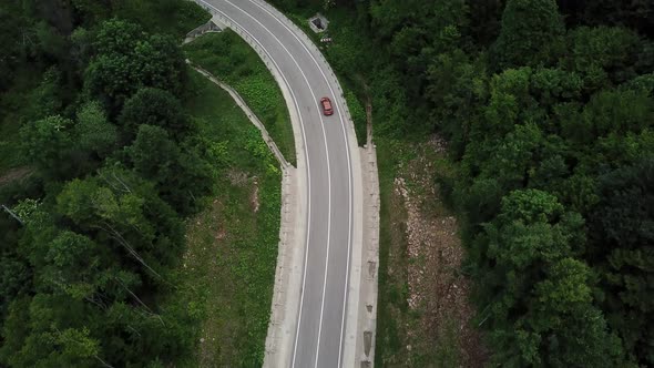 Drone Point of View Tracking Mode Aerial View Flying Over Two Lane Countryside Forest Road with