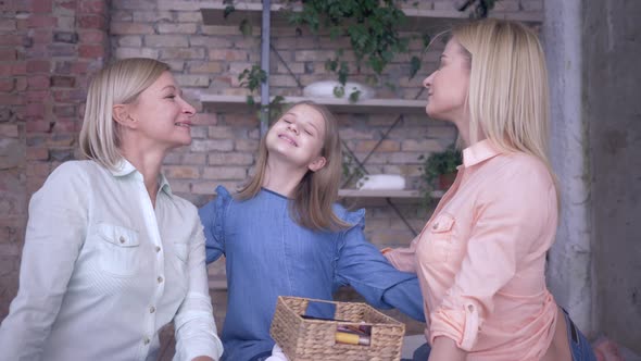 Portrait of Loving Family, Happy Mother Has Fun Talking with Daughters and Hugging While Relaxing at