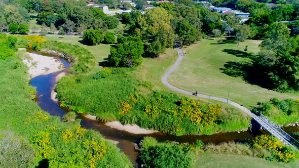 Parkland with people walking on footpath