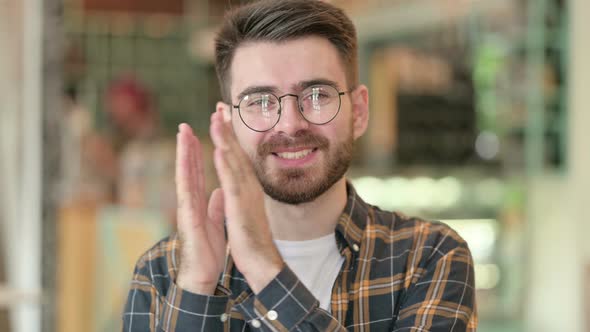 Portrait of Appreciative Young Man Clapping 