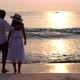 Young asian couple looking beautiful sunset on the beach - VideoHive Item for Sale