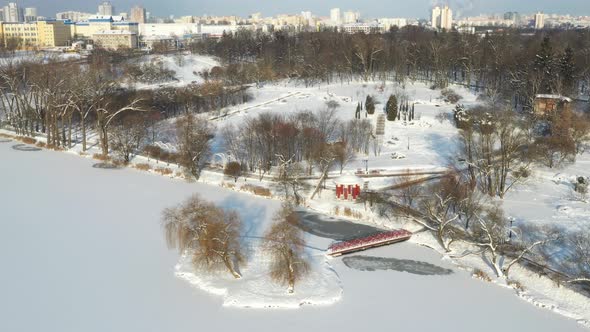 An Island on a Lake with a Bridge in the Winter Loshitsky Park