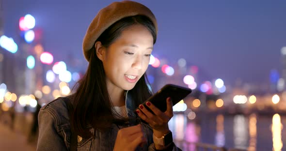 Young woman use of mobile phone at night