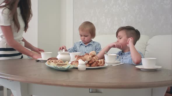 Mum and Dad Joining Their Male Children at the Cafe Table