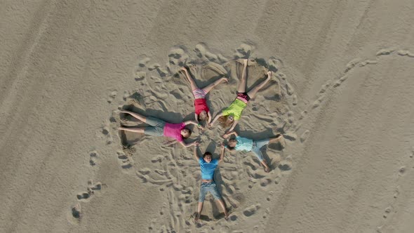 Children Draw on the Sand with Their Feet