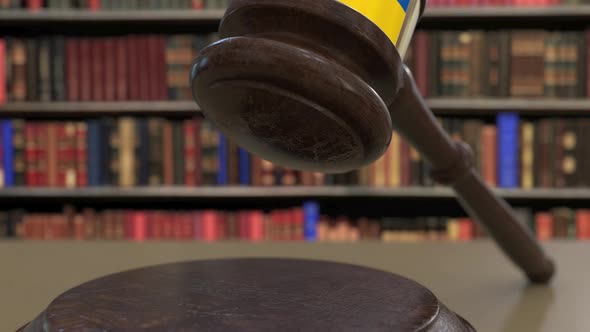 Flag of Ukraine on Falling Judges Gavel in Court