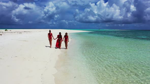 Women posing on beautiful shore beach journey by blue green ocean with white sand background of the 