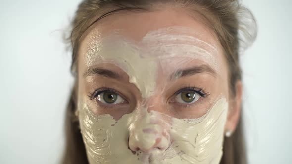 A Young Beautiful Girl Applies a Moisturizing Mask to Her Face