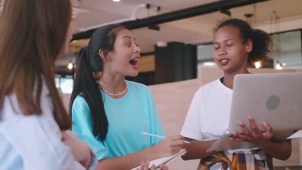 A group of friends discussing homework in a coffee shop.