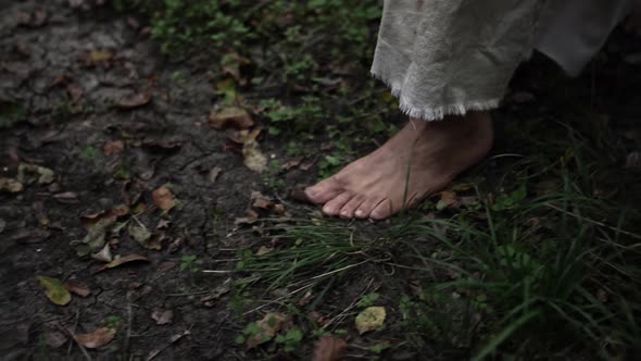 Jesus Christ's Bare Feet Walking In Slow Motion Through Forest