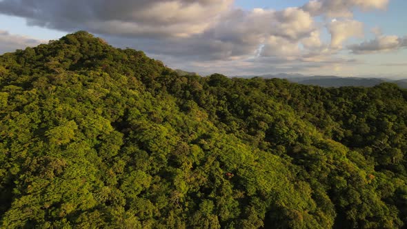 4k drone flying backwards while panning sideways revealing stunning sunset over remote landscape cov