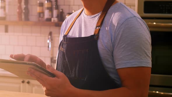 Chef using digital tablet in kitchen