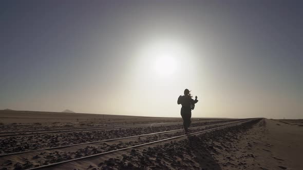 Young Woman Walks at Abandoned Railway Near Garub Railroad Station