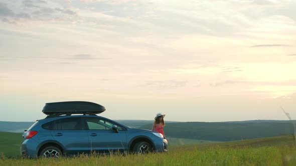 Young Woman Traveler Walking Alone on Green Meadow During Road Trip in Summer