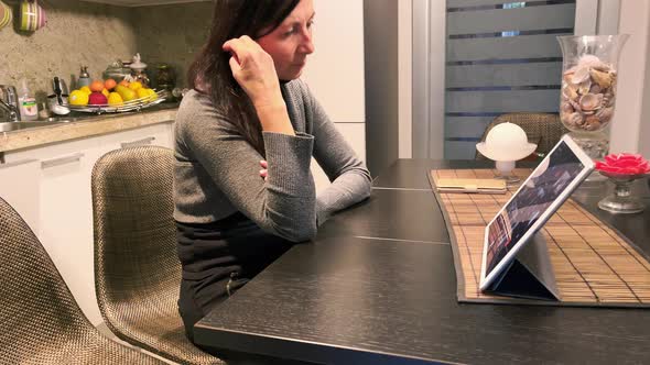 Woman at Home Following School Video Conference on the Tablet