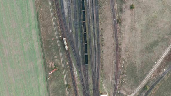 An Aerial Drone View of a Diesel Locomotive Going To Station