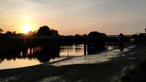 Beautiful sunset on Thames river, London. Kew Railway bridge can be seen on the picture and three pe