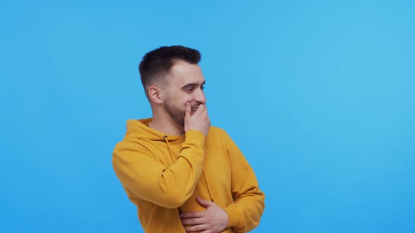 Expressive young man screaming and shouting over vibrant background.