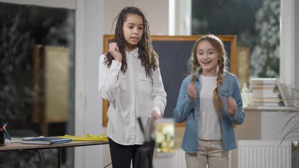 Joyful Cute Schoolgirls Recording Funny Dance on Smartphone in Classroom
