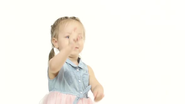 Little Girl Is Playing with Herself. White Background. Slow Motion