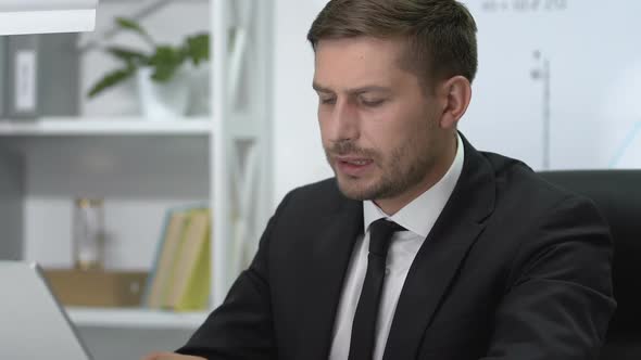 Serious Male Manager Working on Laptop Suddenly Feeling Sharp Ache in Shoulder