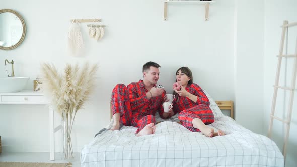 Loving Couple Having Breakfast in Bed