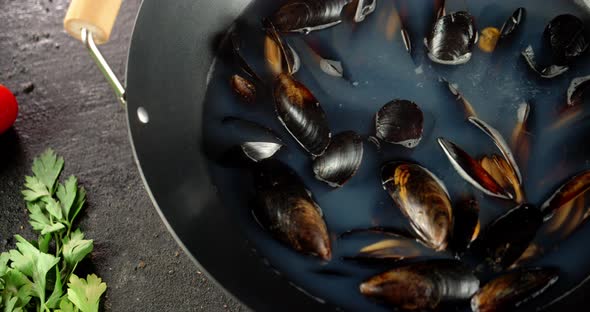 Fragrant Mussels in a Saucepan. On a Black Background.