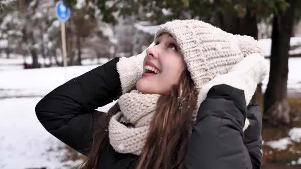 Happy woman enjoying snow in winter