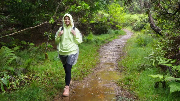 Tourist Moving Through a Tropical Forest with Lush Nature Landscape Under Rain