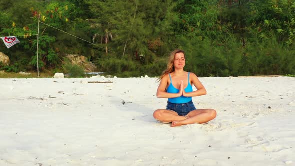 Ladies tanning on relaxing resort beach vacation by clear sea and white sandy background of Thailand