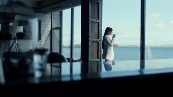 Ceo Woman Enjoying Tea with Ocean Panoramic Window View