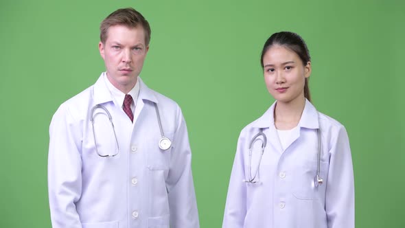 Multi-ethnic Couple Doctors Showing Stop Gesture Together