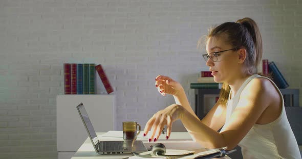 A Young Woman in the Office  Takes Off Her Glasses Headset and Grabs Her Head