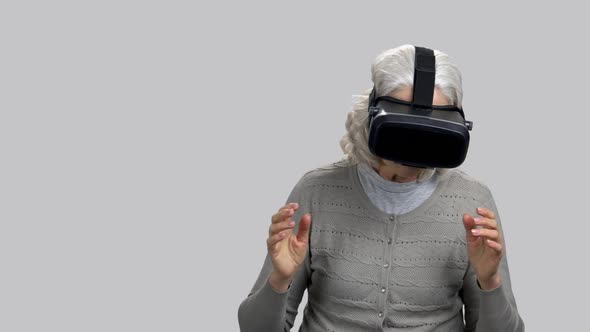 Old Retired Lady Experiencing Virtual Reality and Reacting Expressively