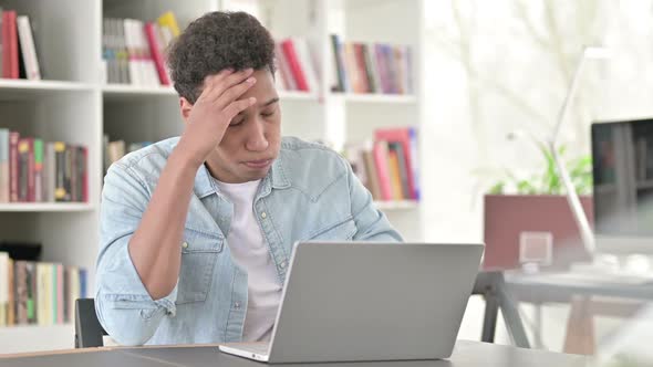 Stressed Young African American Man Having Headache at Work